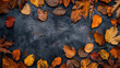 Autumn background with space for text copy space made from leaves in a circular composition on a dark gray grainy background