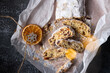 Top view of Christmas stollen decorated with dried orange fruits. Sliced stollen cake. New Year holiday baking. Sweet present. December celebration. Homemade stollen.