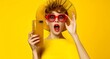Surprised young woman in red sunglasses holding smartphone on yellow background. Modern fashion and technology. Expressive portrait, stylish summer hat. AI