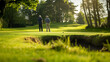 Two golfers in the distance on a lush green course, with a golden sunset creating a tranquil atmosphere.
