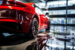 High-end detailing: Gleaming red sports car in car wash with soap suds