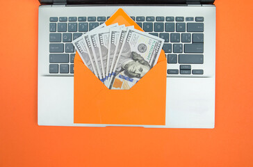 Wall Mural - laptop and orange envelope with dollars