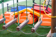 Empty playground with various equipment and toys on green synthetic grass