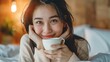 Portrait of smiling happy cheerful beauty pretty asian woman relaxing drinking and looking at cup of hot coffee or tea.
