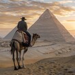 A tourist man wearing a hat riding a camel against the backdrop of the Egyptian pyramids in Giza, during sunset in Cairo, Egypt. 