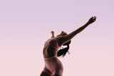 Fototapeta Nowy Jork - Fit ballerina displaying athletic movement in a studio silhouette