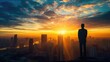 © GulArt - Rear view of a businessman silhouette standing at sunrise in front of skyscraper and viewing the city