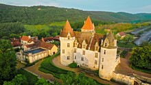 Cinematic Stained Glass Castle With Mullioned Windows And Rooms Opening Into The Valley In France. Aerial View Of Fortress At Golden Sunset In France,
