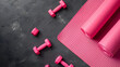 Modern stylish fitness pilates training gym background. Top view to yoga sport mat and pink dumbbells on floor background