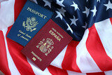 Fototapeta  - Passport of Spain with US Passport on United States of America folded flag close up