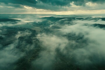 Poster - Aerial view of majestic mountain range with clouds in the sky. Perfect for nature and travel concepts