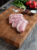 Fototapeta Desenie - Large pieces of chopped pork meat on a beautiful wooden board.