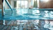 A modern indoor swimming pool with a metal hand rail. Ideal for fitness or leisure concepts