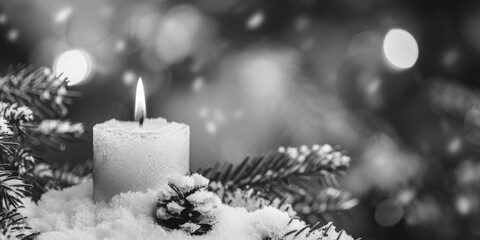Poster - A lit candle on top of a pile of snow, perfect for winter themes