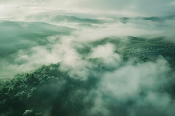Aufkleber - A stunning aerial view of a mountain range covered in fog. Perfect for nature and landscape themes