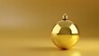 © Fotograf - A shiny gold Christmas ornament on a table. Suitable for holiday decorations