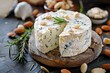 Making delicious snack with blue cheese goat cheese and almonds