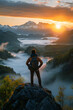 A traveler capturing the beauty of a majestic sunrise over a misty mountain range. A traveler on a highland admires the sunset over the mountain range