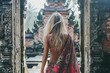 blonde traveler exploring indonesian temple wearing traditional batik sarong cultural travel photography