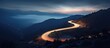 Night-time mountain road winding brightly