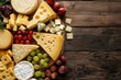Variety of cheeses on wood background