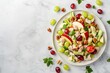 Waldorf salad with space on a plate Ingredients include apples celery grapes chicken and mayonnaise Ready to eat on a white marble plate top view