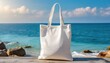 Blank cotton white Shopper bag, white tote bag mockup on blurred seaside. The summer sun, contrasting with the vibrant blue sea in the background 