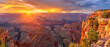 © domi002 - Vibrant colors fill the sky as the sun sets over the majestic Grand Canyon cliffs.