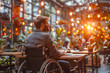 Man in wheelchair enjoying cafe ambience at sunset