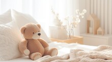 A Cute Teddy Bear Sitting On A Bed With A White Blanket And A White Pillow
