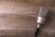 Studio microphone for podcast on wooden background.