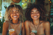 Joyful Young Women Enjoying Refreshing Drinks at a Tropical Cafe