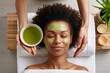 ©  J. GALIÑANES STOCK - An ethnic African woman lying in a beauty salon receiving a natural herbal facial treatment. Beauty, natural and personal care treatment.