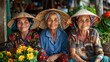 Women of Vietnam. Women of the World. Three smiling elderly women wearing traditional Asian conical hats sitting together in a market setting  #wotw