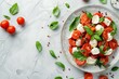Healthy caprese salad with tomatoes mozzarella basil on marble Italian cuisine