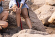 Black woman trekker grab her knee suffer from knee injured while trekking on the mountain