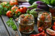 Eggplant caviar and vegetables in jars on table
