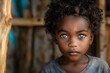 Intense black boy with blue eyes and curly hair