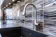 Modern kitchen with gray ceramic wall tiles black countertop undermount sink and steel faucet