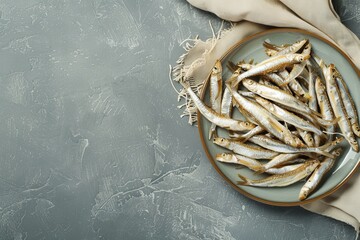 Wall Mural - Plate of anchovies and napkin on table top view Space for text