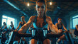 © Irina - People biking in Spinning class at modern gym, exercising on stationary bike. A sporty lifestyle