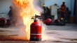 Demonstration of fire extinguisher use: safety equipment training ensuring proper handling and effective utilization in emergency situations for safety measures.
