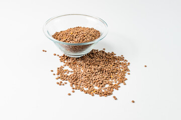 the lentils are in a glass bowl and scattered side by side on a white background