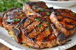 Grilled pork chops with grill marks on a plate