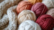 Close-up Of Several Balls Of Yarn Neatly Stacked On Top Of Each Other With Varying Colors And Textures.