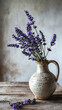 A bunch of lavender flower in a rustic textured ceramic pot on an old wooden table against light wall. Vintage country style home interior