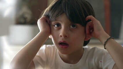 One bored pensive little boy feeling lazy and drowsy, close-up face of contemplative male caucasian kid pondering solution