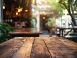 Rustic outdoor café or restaurant with wooden table surrounded by greenery.