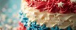 Close-up of patriotic colored tiered cake with stars and sprinkles