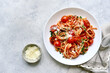 Traditional italian pasta with grilled tomatoes, parmesan and garlic. Top view with copy space.